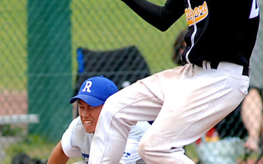 Stuttgart&#39;s Justin Phelps is safe at third as the ball skips by Ramstein&#39;s John Collett in the title game.
