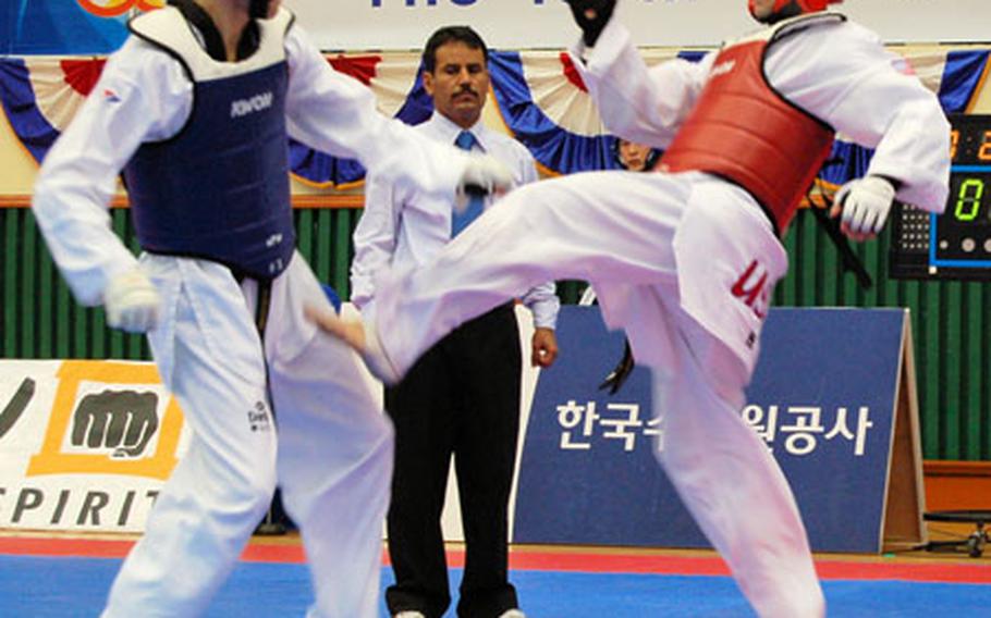 Featherweight Spc. Donovan Rider, right, throws a kick at Sgt. Dennis Bekkers of the Netherlands during the 18th Military World Tae Kwon Do Championship on Monday. Rider lost the match, 6-4.