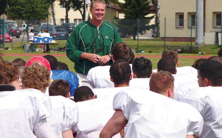 Camp director John Shannon, offensive coordination for the Marshall University Thundering Herd in Huntington, W.Va., addresses participants in the Kaiserslautern Youth Tackle Football Camp after a Friday practice session at Miesau, Germany. More than 90 players attended the camp, which was instructed by college football coaches from the States.