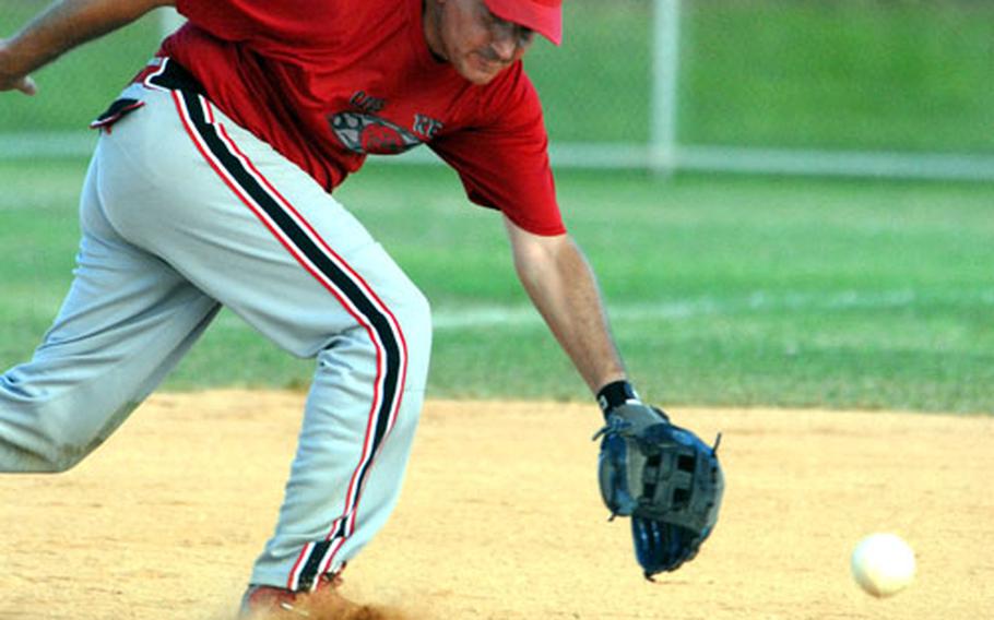 A ground ball bounces just out of the reach of third baseman K.J. Basso of Club Red.