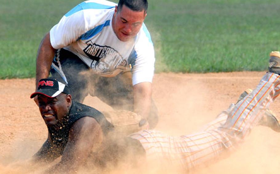 Lance Jones of Marine Corps Base Camp S.D. Butler slides in ahead of the tag of Marine Wing Headquarters Squadron-1 third baseman Daniel Alvarez during Saturday&#39;s championship game in the 2008 Marine Corps Community Services Okinawa Commanding General&#39;s Softball Tournament. Base won its sixth straight CG Cup, beating MWHS-1 11-1 in five innings in the second game of a two-game final. MWHS-1 won the first game 10-5. The tournament was the final tuneup for next month&#39;s Marine Far East Regional Tournament at Camp Foster. (See scores below)