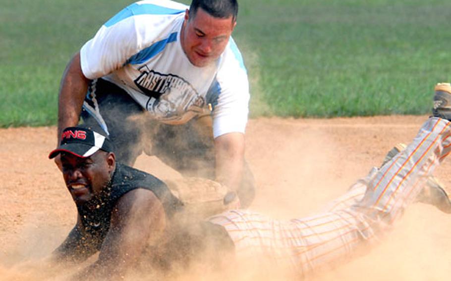 Lance Jones of Marine Corps Base Camp S.D. Butler slides in ahead of the tag of Marine Wing Headquarters Squadron-1 third baseman Daniel Alvarez during Saturday's championship game in the 2008 Marine Corps Community Services Okinawa Commanding General's Softball Tournament. Base won its sixth straight CG Cup, beating MWHS-1 11-1 in five innings in the second game of a two-game final. MWHS-1 won the first game 10-5. The tournament was the final tuneup for next month's Marine Far East Regional Tournament at Camp Foster. (See scores below)