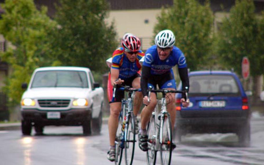 Martin Heinz of Spangdahlem (right) fends off a challenge from James Sharp of Kaiserslautern during Sunday’s 51.5-kilometer road race in Spangdahlem, Germany. Heinz was fastest overall in 1 hour, 21 minutes, 11 seconds in this final event of the 2008 U.S. Forces Road Cycling Series. Sharp was second in 1:21:25.