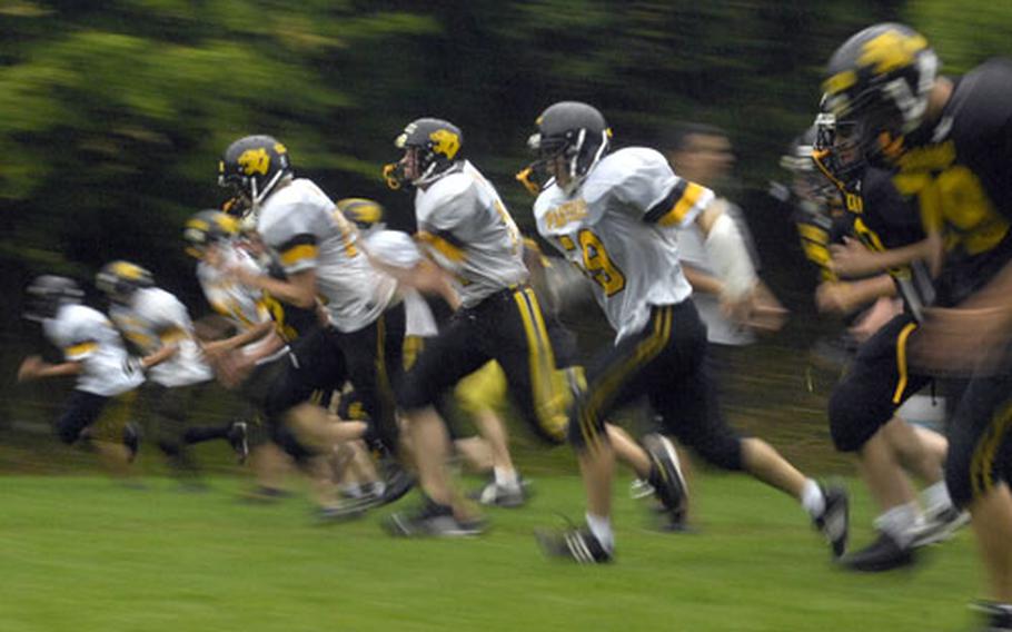 Varsity and JV warm up together with running drills at the beginning of practice on Patch Barracks Sept. 4th. Patch High School is moving up to Division 1 football this season.