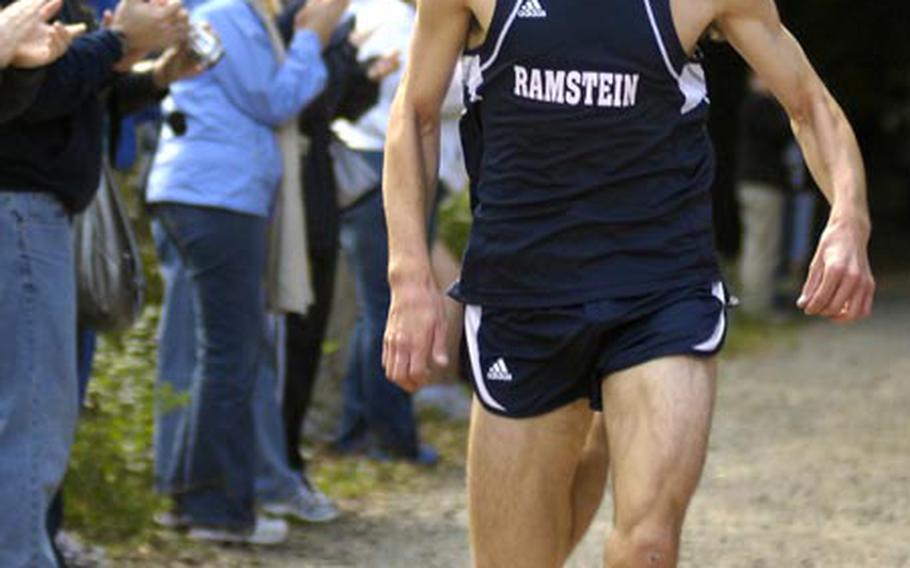 Kelis Seacrest, a senior from Ramstein High School, pushes hard towards his first-place finish at the cross country course in Vogelweh, near Kaiserslautern, on Saturday. John Rynecki from Heidelberg finished second and Alex Cornelius of Mannheim third.