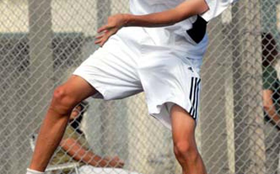 Junior and reigning Far East Tournament boys singles champion Kyle Sprow of Kadena serves it up to Jared Knox of Kubasaki during Thursday&#39;s Okinawa Activities Council regular-season match at Kubasaki High School, Camp Foster, Okinawa.