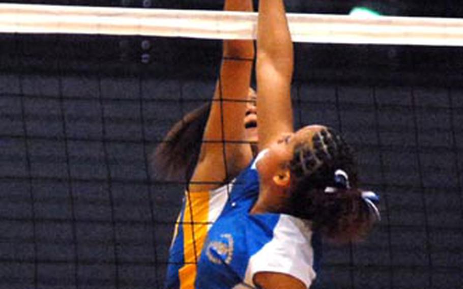 Wiesbaden&#39;s LeAndre Thomas and Ansbach&#39;s Jackie Pohl joust at the net in their Division II game in Ramstein on Friday. Wiesbaden beat Ansbach 25-15, 22-25, 15-3.