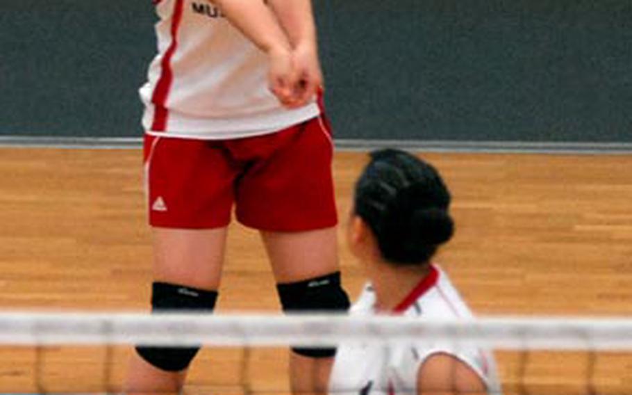 Menwith Hill&#39;s Stephanie Gomez keeps her eyes on the ball as she sets up a shot, as teammate Susan Shorkey watches. The Mustangs beat Lajes in a Division IV quarterfinal 25-12, 25-11 in Kaiserslautern on Friday.