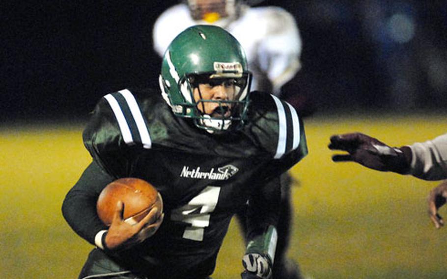 AFNORTH quarterback E.J. Ruiz looks for daylight as he carries the ball in Saturday’s Division III title game against Baumholder. AFNORTH rolled to the championship with a 60-14 victory.