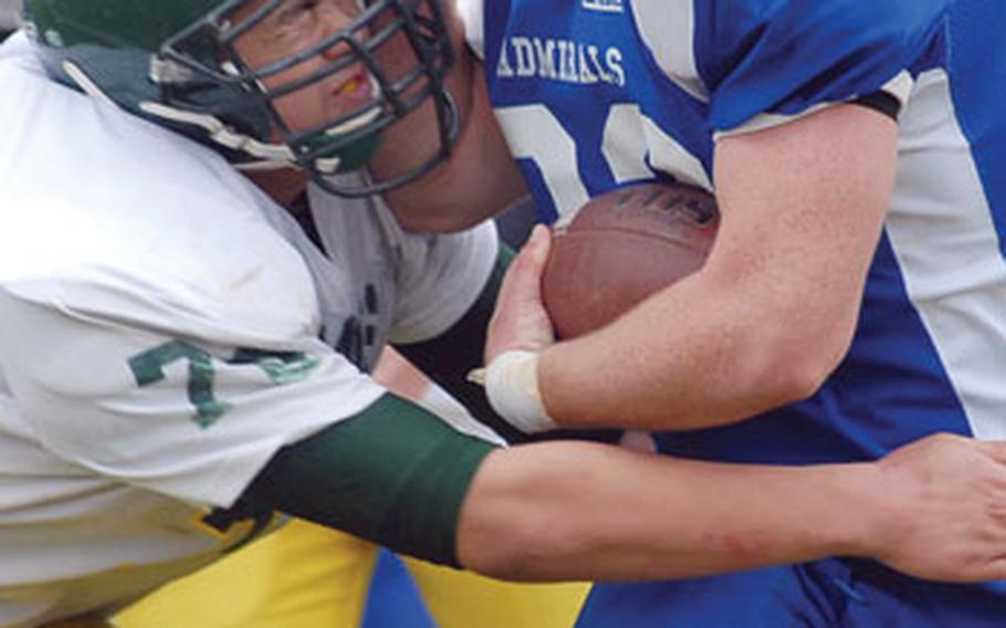 Alconbury’s Yul McGrath, left, and Rota ball carrier RJ Curley collide during Saturday’s Division IV championship game in Baumholder. Rota beat Alconbury 22-21 to claim the championship.