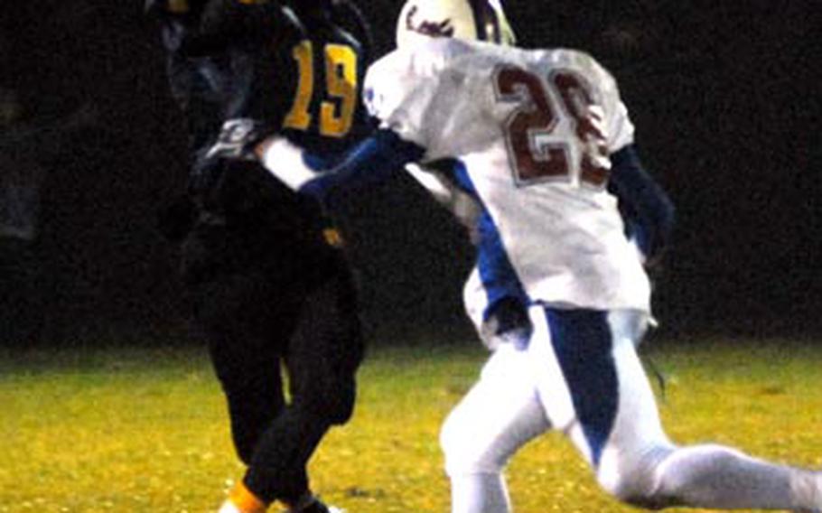 Despite pressure from Ramstein&#39;s Jonathon Melendez, Heidelberg QB Jimmy Montfleury throws the winning TD pass toChris Cuthbert in the Division I final on Saturday night. Heidelberg took the crown with a 9-6 win.