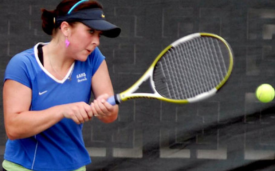 Seoul American junior Kennedy Allen raps a backhand return to Kadena junior Elissa Mason during Thursday&#39;s girls singles championship match.