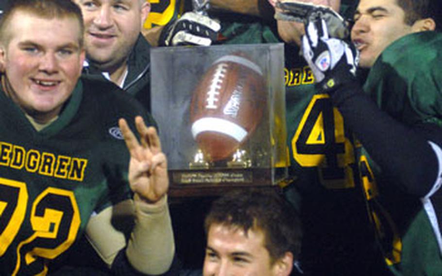 Robert D. Edgren Eagles players and coaches surround the championship trophy after the Nov. 1 Far East High School Class A football championship game.