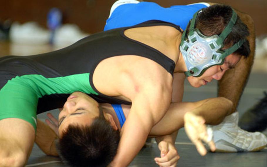 Kubasaki senior Scott Wood, a three-time reigning Far East champion, gets the upper hand on Takeichiro Murayama of Urasoe Industrial High School in a 108/115-pound semifinal bout during Saturday’s 2nd Okinawa-American Friendship Wrestling Tournament at Nakayoshi Fitness & Sports Center, Kadena Air Base, Okinawa.
