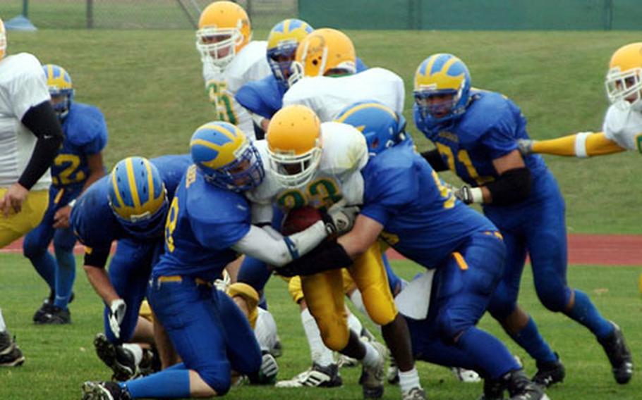 Ansbach linemen Tim Abel, left, and T.J. Dignan put the clamps on Cologne ball carrier Yves Balekelay during Ansbach’s 59-0 victory at Ansbach, Germany, on Oct. 11. Closing on the Cologne runner is Donavan Purdum (71).