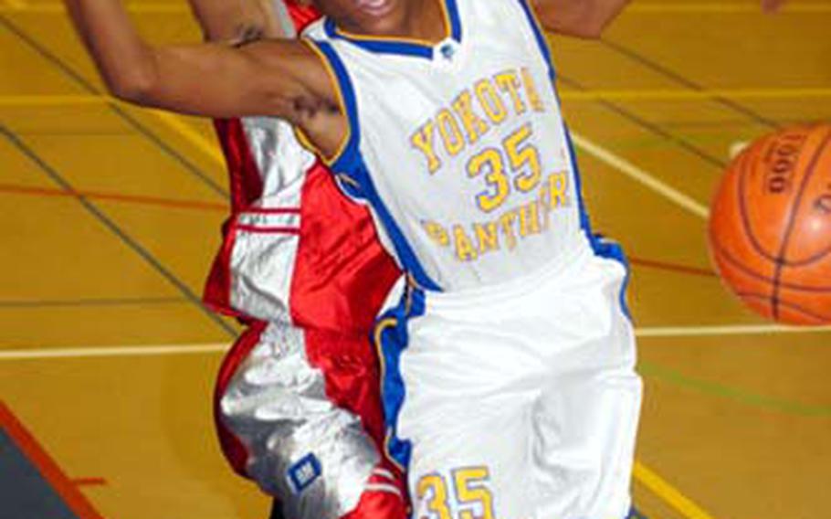 Kenneth Dixon, left, of the E.J. King Cobras and Keron Brown of the Yokota Panthers chase a loose ball during Saturday&#39;s DODDS-Japan Basketball League boys high school game at Capps Gym, Yokota High School. The Panthers beat the Cobras 62-30.