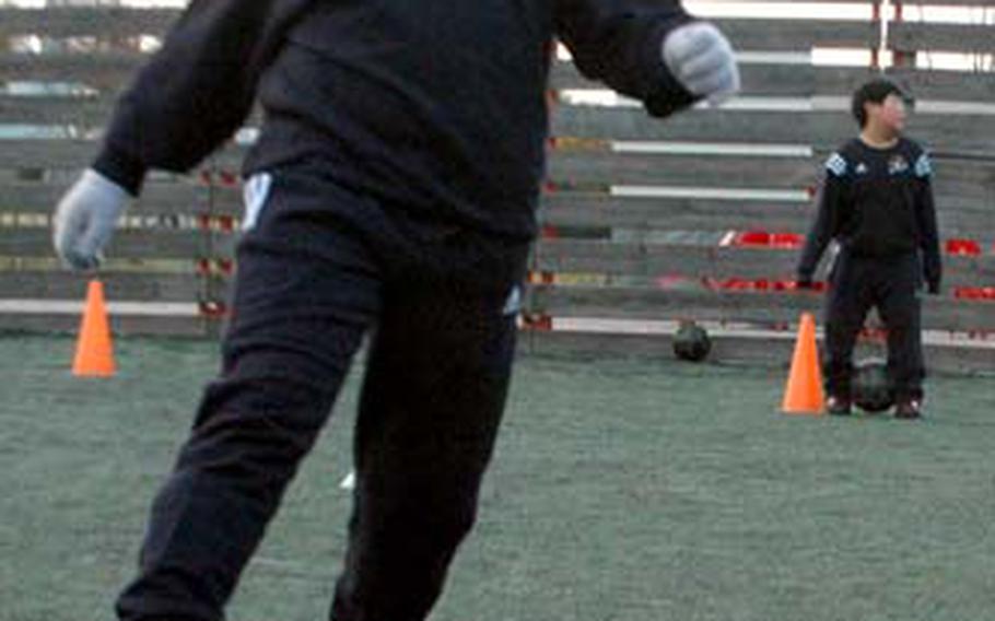 Camille Pereira, 8, dribbles through a drill Nov. 18 Cha Byum-geum, a soccer school in Seoul. Pereira, the daughter of Staff Sgt. Elizabeth Perez and Philip Perez, began attending the all-Korean program in May.