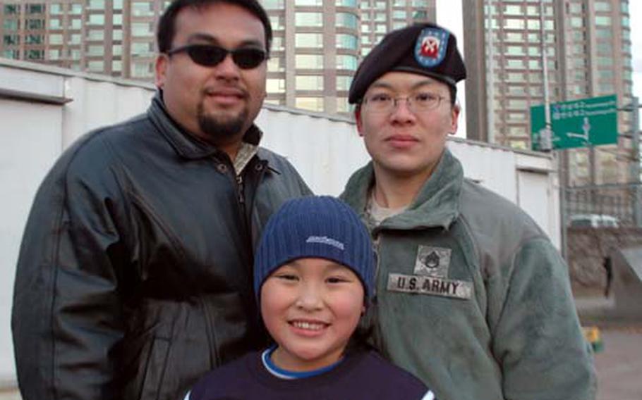 Camille Pereira with her parents, Philip Perez and Staff Sgt. Elizabeth Perez.