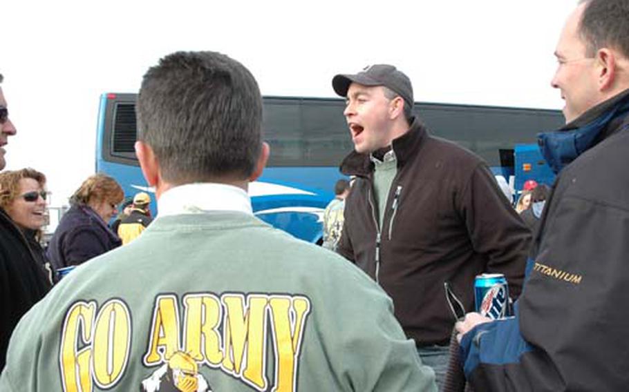 Tom O&#39;Donnell, center, jokes with friends at their tailgate outside the Army-Navy game. O&#39;Donnell played for Army and graduated in 1991.