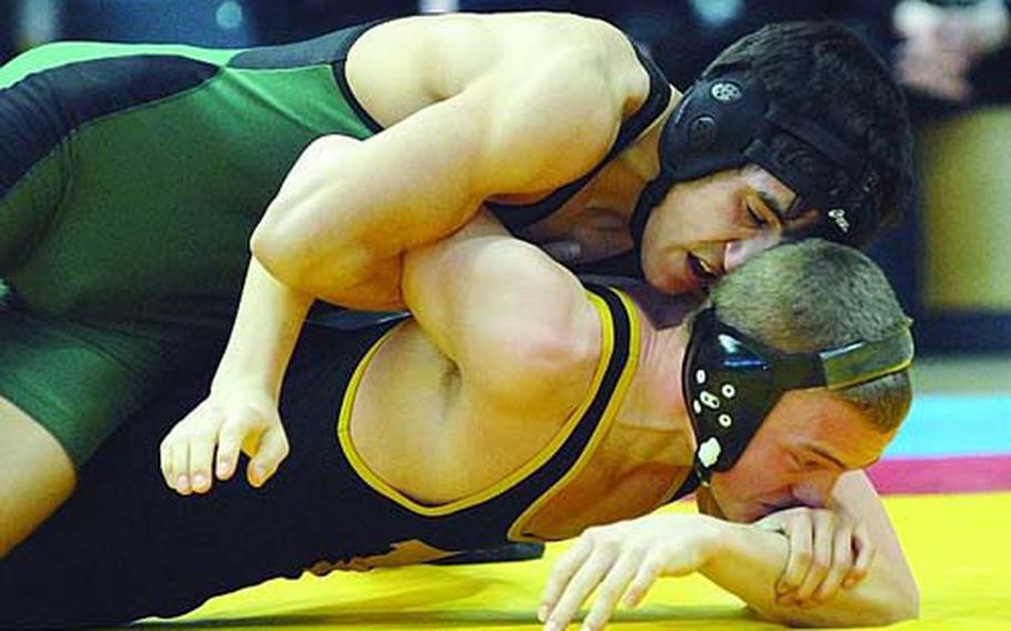 Chris Campos of Naples, top, puts the pressure on Hanau’s Aubry Blad in the 119-pound final in the DODDS-Europe wrestling championships in Wiesbaden, Germany, in February. Campos, who won the title, this year is aiming for the 125-pound crown, although last weekend he wrestled at 135 pounds in hopes of finding tougher competition.