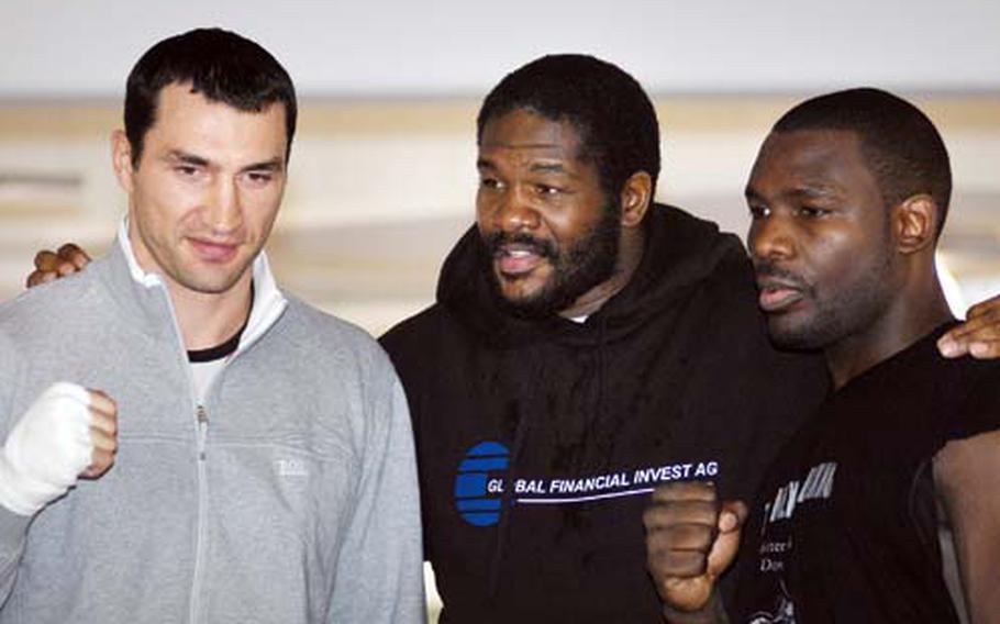 Riddick “Big Daddy” Bowe, center, poses with IBF/IBO/WBO heavyweight champion Wladimir Klitschko, left, and Klitschko’s challenger Hasim Rahman, right, during a press event at a Mercedes-Benz dealership near Heidelberg on Wednesday. Bowe, a former undisputed heavyweight champion, will be fighting on the undercard of the Klitschko-Rahman world title bout scheduled for Saturday night in Mannheim.