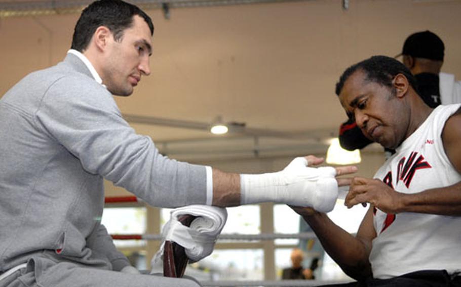 Wladimir Klitschko, the current heavyweight champion, gets taped by trainer Emanuel Steward during a press event at a Mercedes-Benz dealership near Heidelberg Wednesday.