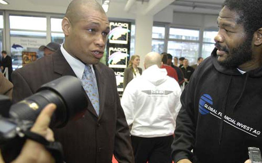 Herb Smith, flanked by Riddick Bowe, talks to the media during a press event at a Mercedes-Benz dealership near Heidelberg on Wednesday. Smith, a civilian for the Army in Kaiserslautern, serves as the manager for the former heavyweight champion Bowe, who fights Saturday night in Mannheim.