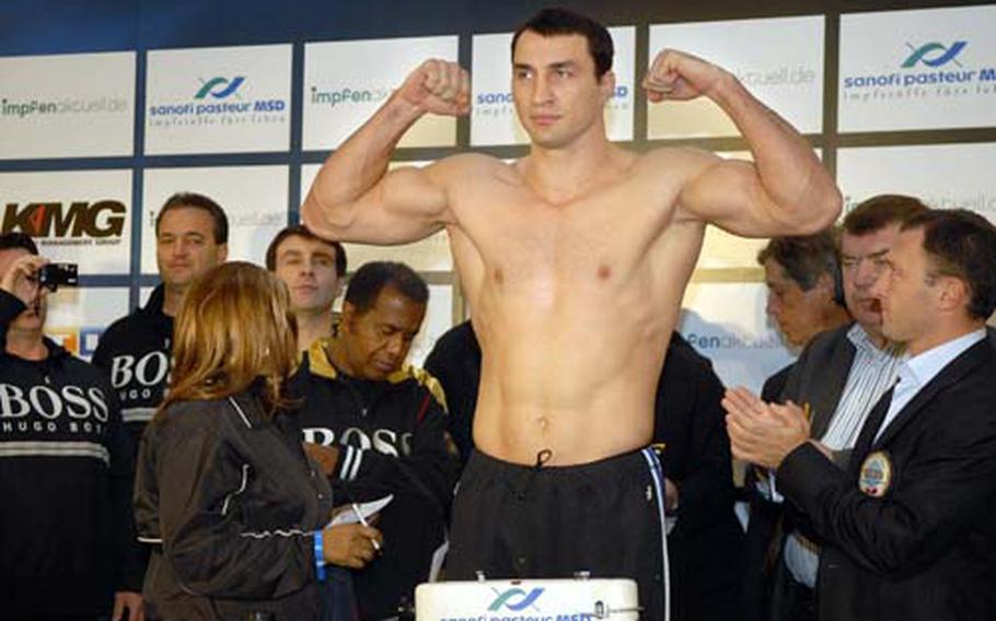Wladimir Klitschko, the defending heavyweight champion, flexes during his official weigh-in. Klitschko weighed in at 245 pounds, and will face Hasim Rahman Saturday for the title fight.