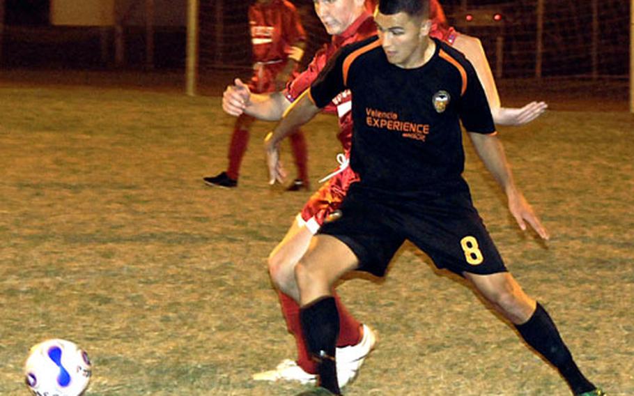 3rd Marine Logistics Group forward/mid Adam R. Rivera (8) battles Marine Corps Base Camp S.D. Butler midfielder Mike Muller for the ball Friday at the championship game of the 2008 Far East Regional Soccer Tournament on Camp Foster, Okinawa. 3rd MLG repeated its tournament championship, winning the match 4-2.