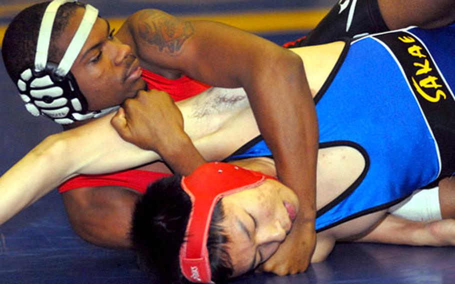Senior Cameron Butts of Nile C. Kinnick wraps up Yutaro Nakamura of Sakae High School, a Japanese school from nearby Saitama Prefecture, during the 135-pound championship bout in the 2008 All-Japan Invitational Wrestling tournament at Yokota High School. Butts decusioned Nakamura 2-0 (6-0, 6-2).