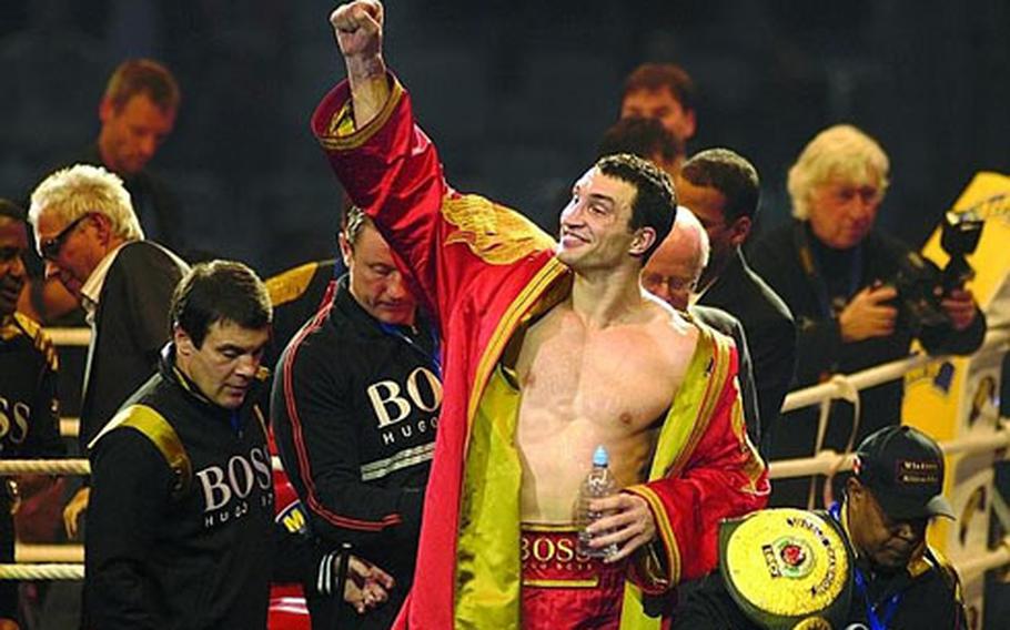 Wladimir Klitschko reacts to cheering fans after beating Hasim Rahman to retain his IBF, WBO, IBO heavyweight world championship titles at SAP Arena in Mannheim Saturday.