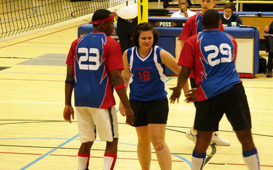 Stuttgart’s Rachel Black accepts congratulations from her co-rec teammates Eric Latson (23) and Mark Fleming (29) Sunday during the Stallions’ 25-18, 20-25, 15-11 victory over Mannheim.