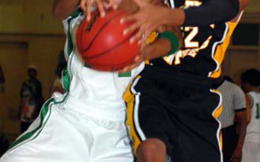 Kubasaki Dragons junior Dionte Watie and Kadena Panthers junior Taiyo Robertson battle for the ball during Wednesday&#39;s Okinawa Activities Council boys basketball game at the Dragons&#39; Den, Kubasaki High School, Camp Foster, Okinawa. Kadena won 86-66.