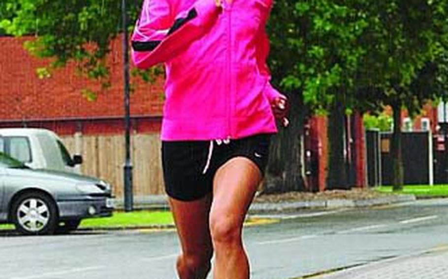 Trasy Rincan, a senior airman in the 100th Security Forces Squadron, runs in the rain Sept. 5 at RAF Mildenhall. Senior Airman Rincan is one of 15 runners chosen to represent the Air Force in the Armed Forces Cross Country Championship.