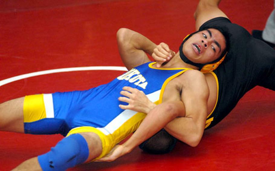 Yokota&#39;s Nick Guzman applies a chest crusher to J.C. Henderson of Kadena during Saturday&#39;s 122-pound championship bout. Guzman, who earlier Saturday upset three-time Far East gold medalist Scott Wood of Kubasaki, pinned Henderson in 3:36.