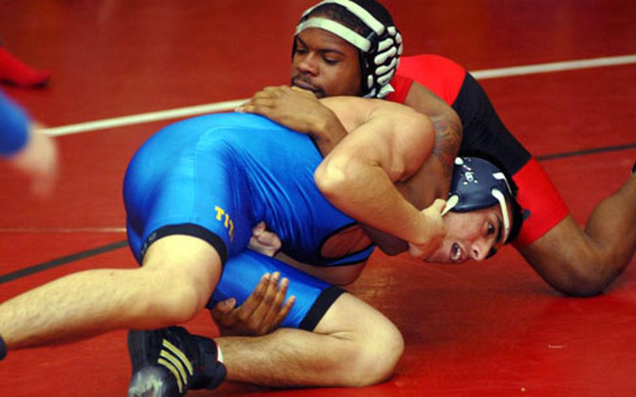 Kinnick senior Cameron Butts, right, gets the upper hand on Joey Buccilli of St. Mary’s International during Saturday’s 135-pound final in the Nile C. Kinnick Invitational "Beast of the Far East" Wrestling Tournament at Yokosuka Middle School, Yokosuka Naval Base, Japan. Butts won by pin in 1 minute, 21 seconds and earned Outstanding Wrestler honors, as he did during last February’s DODDS-Pacific Far East Tournament on Okinawa. But he’d gladly trade those individual honors for team success.