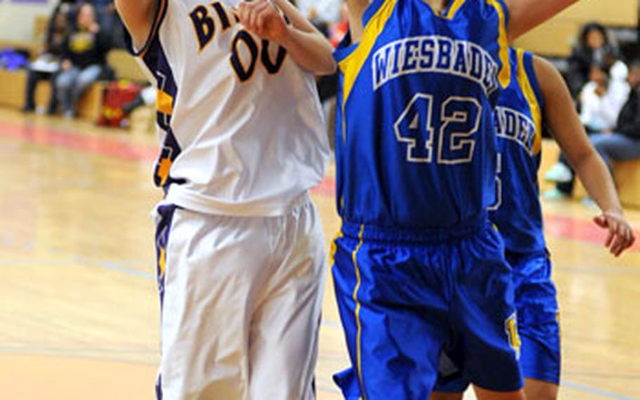 Mannheim&#39;s Tristan Ledesma, left, attempts a shot over Wiesbaden&#39;s Taylor Dore, in a DODDS-Europe girls high school basketball game in Mannheim on Saturday. Mannheim won, 42-33.