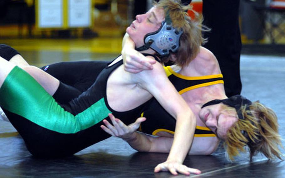 Jacob Bishop of Kadena, right, tries to torque the shoulders of Kubasaki&#39;s Jon Goddard to the mat during Saturday&#39;s 135-pound bout in the 3rd Okinawa-American Friendship Wrestling Tournament at Kadena Air Base, Okinawa. Goddard won by decision 2-1 (1-0, 1-2, 5-3).