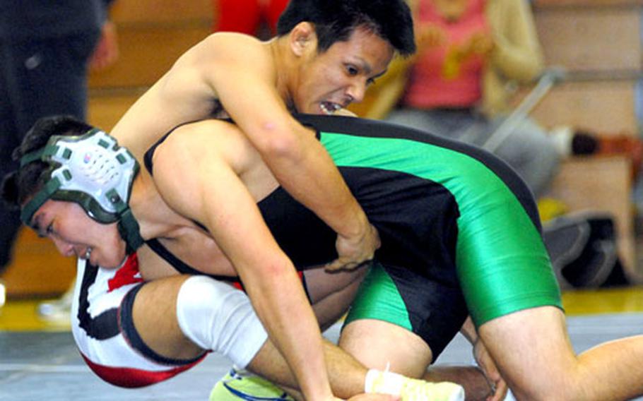 Kazusa Ichiara of Okinawa tries to gut-turn three-time Far East Tournament gold medalist Scott Wood of Kubasaki during Saturday&#39;s 122-pound bout. Ichiara won by decision 2-0 (1-0, 1-0).