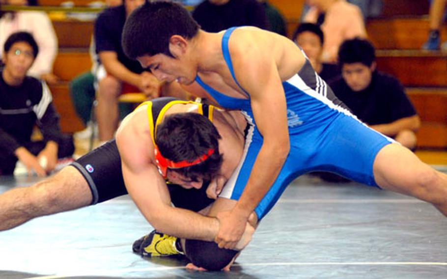 Harry Bloom, left, of Kadena attempts a leg lift on Yusuke Nakamura of Okinawa during Saturday&#39;s 148-pound bout. Bloom, a reigning Far East Tournament gold medalist, pinned Nakamura in 3 minutes, 44 seconds.