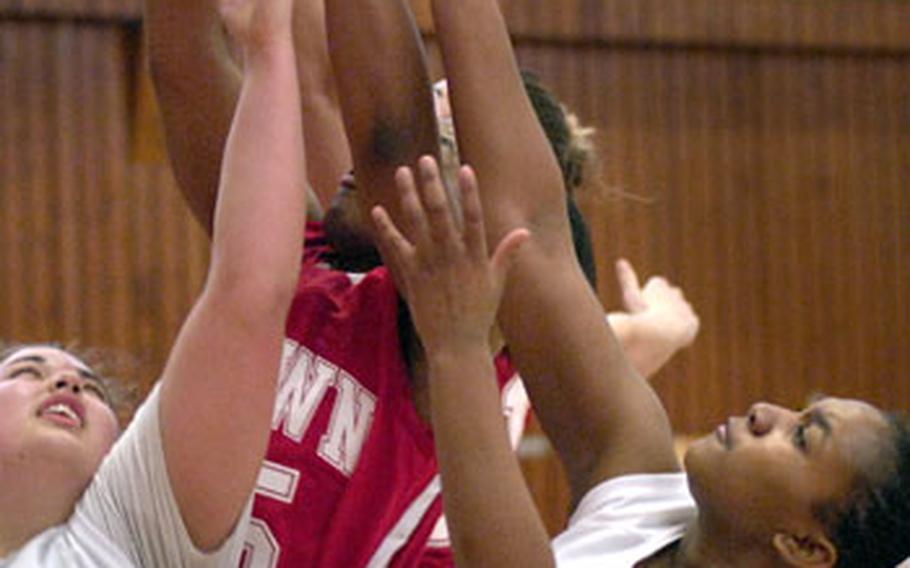 Erica Turner, right, and Lisa McBride, left, of Lakenheath fight off Kaiserslautern players for a rebound.