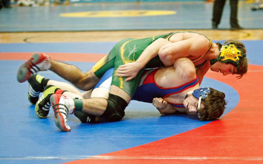 Defending European 135-pound champion Chris Lyon of St. John’s International School of Waterloo, Belgium, applies pressure to Ramstein’s Ryan Dorofee last Saturday in the 145-pound championship bout of the Ramstein Rumble wrestling tournament. Lyon pinned Dorofee in 1:57 to run his record to 17-0 for the season and 103-28 for his career.