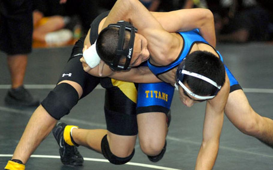 Taehon Paschal, left, of Kadena and Joey Buccilli of St. Mary's International go at it during Saturday's 129-pound championship bout in the 2nd Rumble on the Rock Wrestling Tournament. Buccilli eked out a 2-0 decision (3-0 overtime clinch, 2-1). Coaches are calling for a return of international schools such as St. Mary's to DODDS-Pacific's Far East Tournaments, which became DODDS-only affairs starting in 2004.