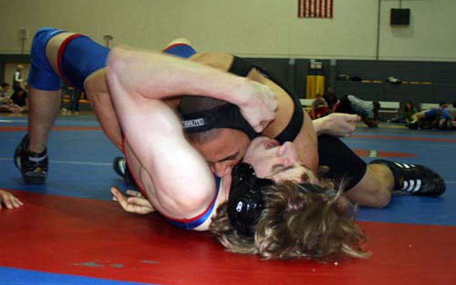 During second-round action at Saturday’s Western Sectional wrestling tournament at Ramstein, Michel Russell of Baumholder pins Ramstein’s C.J. Wiedeman in the 152-pound division.