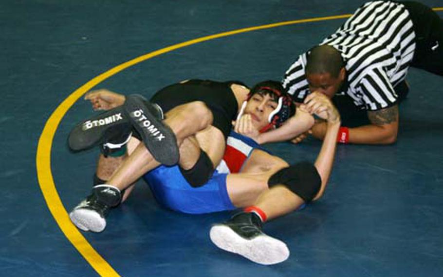 Edgar Acosta of Baumholder applies a reverse half-nelson and leg ride to pin Andres Gayton of Ramstein during their 135-pound bout at Saturday’s Western Sectional wrestling tournament at Ramstein. The top two finishers from each of Saturday&#39;s four sectionals plus four wild card wrestlers qualify for the DODDS-Europe championship this coming Friday and Saturday.