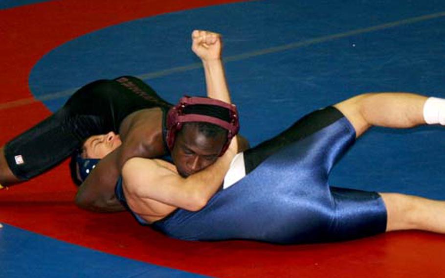Prince Owusu, a 140-pounder from Baumholder, pins Ramstein’s Austin Schmidt during the second round of Saturday’s Western Sectional wrestl;ing tournament at Ramstein.