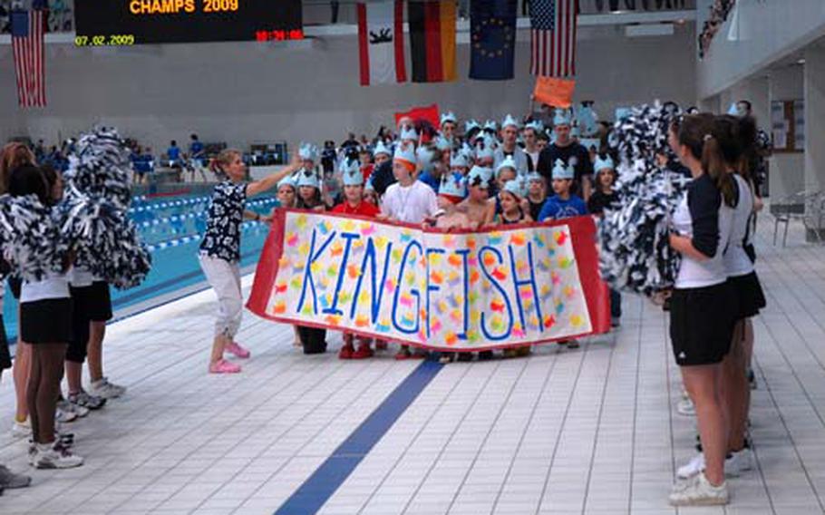 The Aviano Sea Dragons from Aviano Air Base, Italy, were all smiles during the opening parade of the 2009 European Forces Swim League Championships at Berlin’s Europa Sportpark Saturday.