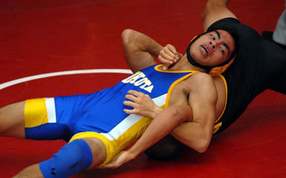 Yokota’s Nick Guzman applies a chest crusher to J.C. Henderson of Kadena during the 122-pound championship bout in the Nile C. Kinnick Invitational "Beast of the Far East" Wrestling Tournament at Yokosuka Naval Base, Japan, on Jan. 10. Guzman, who earlier that same day upset three-time Far East champ Scott Wood of Kubasaki, pinned Henderson in 3:36. Guzman says despite his victories over Henderson and Wood, that doesn’t install him as an automatic favorite to win the Far East Tournament title.