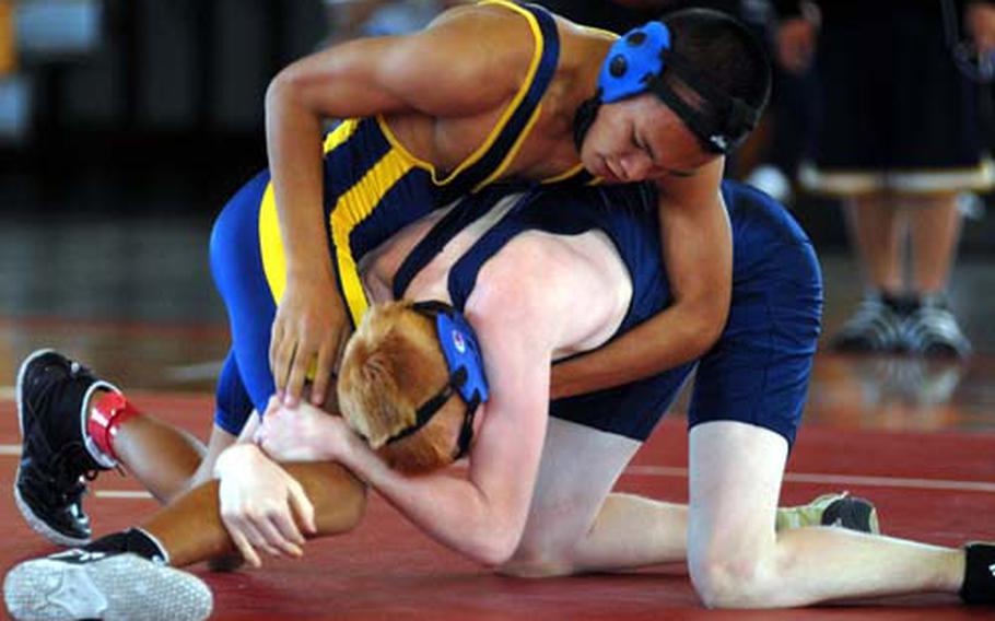 Conner Murphy of Guam High gets the upper hand on Geoffrey Furner of Seoul American during Wednesday's 108-pound round-robin bout in the 2009 DODDS-Pacific Far East High School Wrestling Tournament at Foster Field House, Foster Athletics Complex, Camp Foster, Okinawa. Murphy decisioned Furner 2-0 (6-1, 8-4).