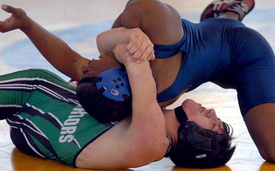 Daegu American&#39;s Greg Jones, bottom, wrenches the shoulders of Seoul American&#39;s Demetrius Johnson toward the mat for a two-point tilt during Wednesday&#39;s 158-pound round-robin bout in the 2009 DODDS-Pacific Far East High School Wrestling Tournament at Foster Field House, Foster Athletics Complex, Camp Foster, Okinawa. Johnson rallied to decision Jones 2-0 (1-0 overtime clinch, 3-2).